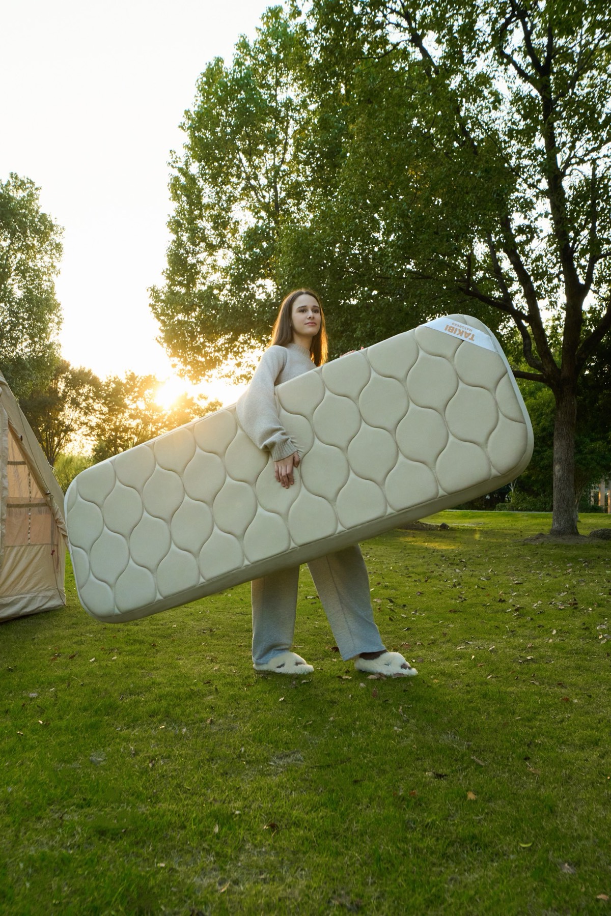 Woman sleeping comfortably on Samtopia inflatable camping mattress in tent