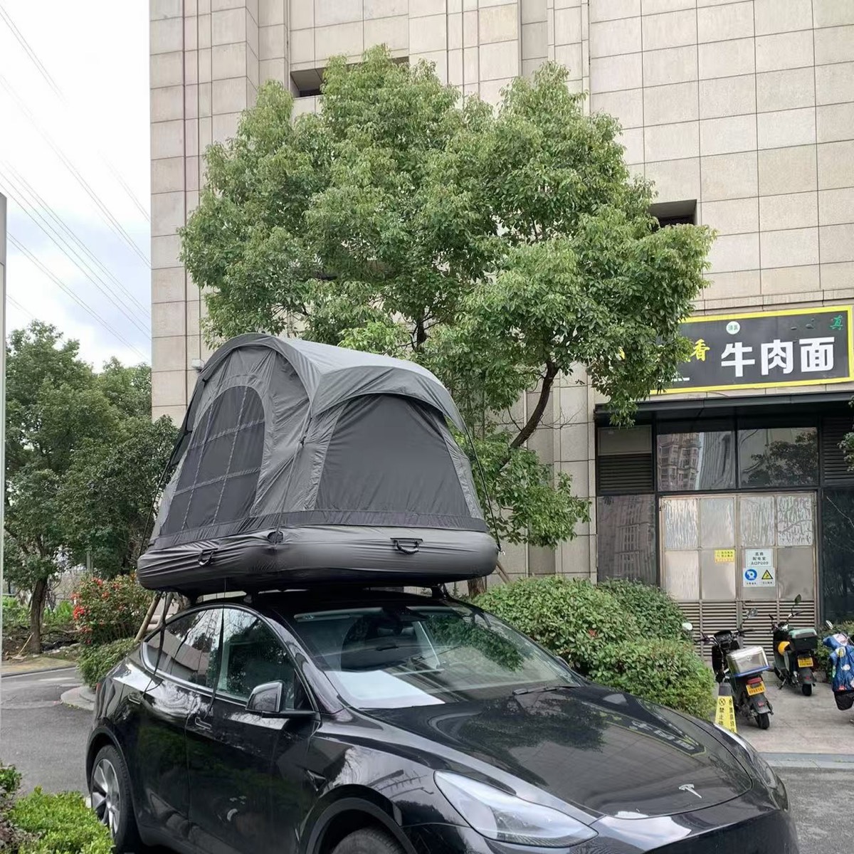 Rooftop tent with Samtopia inflatable mattress on Tesla vehicle for outdoor camping
